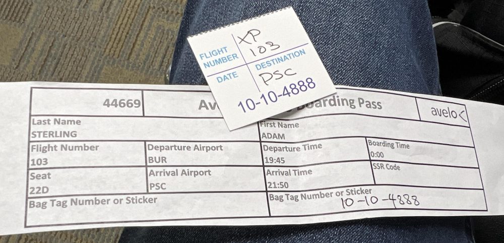 Rectangular slip of paper with flight and boarding information. 